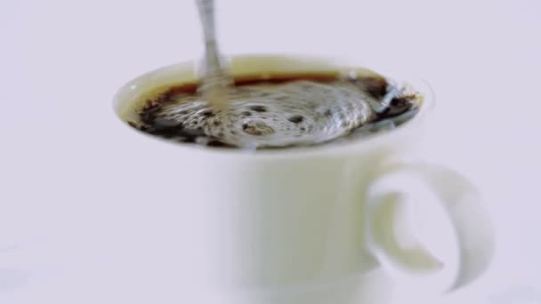 Milk or cream is poured into coffee. — Stock Video