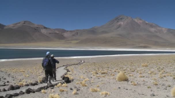 Hikers near the shore of Laguna Miniques — Stock Video