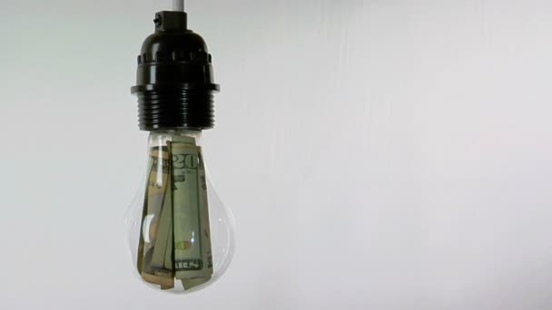 A light bulb contains dollar bills — Stock Video