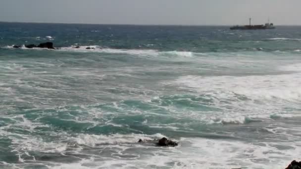 Волны катятся к берегу с кораблем — стоковое видео