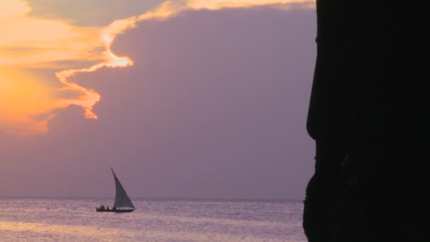 A sailboat silhouetted against sunset — Stock Video