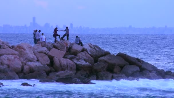 Folk går på en vågbrytare nära Beirut — Stockvideo