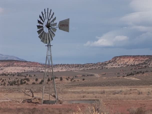 Windmill standing on a desert plain — Stock Video