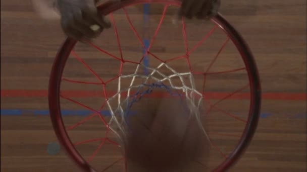 Player hangs onto the hoop — Stock Video