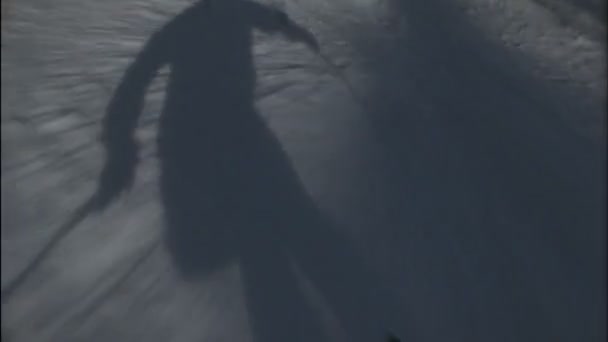 A skiers shadow precedes him — Stock Video