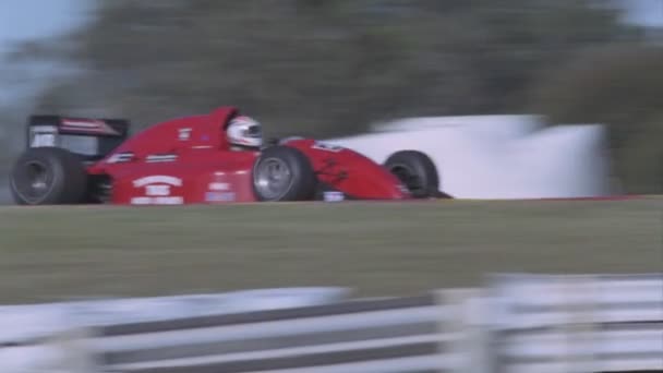 Race cars speed around a sharp — Stock Video