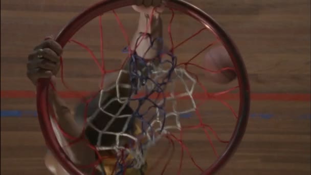 Player hangs onto the hoop — Stock Video