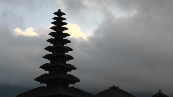 Temple stands silhouetted against sky — стоковое видео