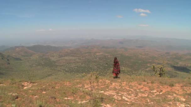 A masai warrior walking along landscape — Stock Video