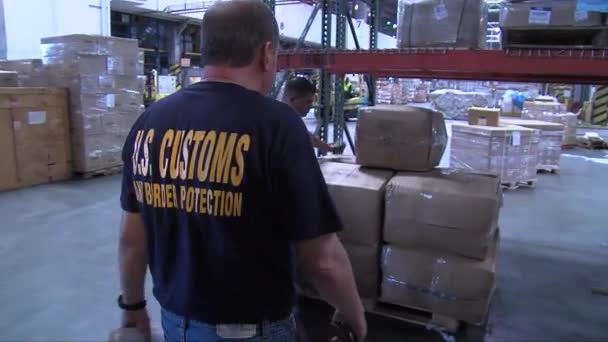 Security agents search through a warehouse — Stock Video