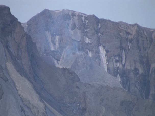 Smoke rises from rocky mountain — Stock Video