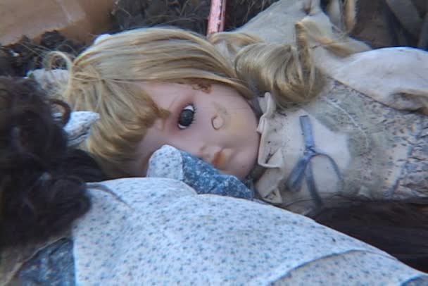A child's doll lies in the rubble — Stock Video