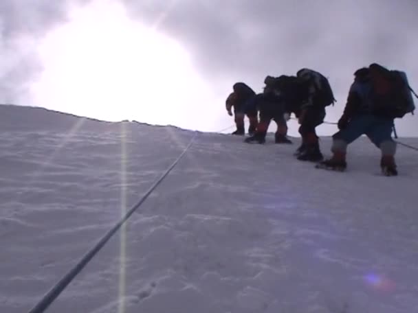 Climbers ascend an icy slope — Stock Video