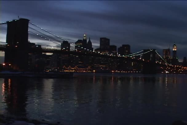 Bridge and skyline glow at golden hour — Stock Video