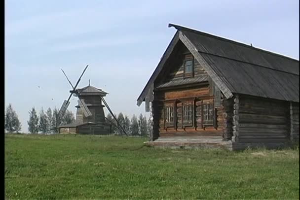 Wooden house and wooden windmill — Stock Video