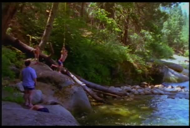 Boy dives into a watering hole — Stock Video