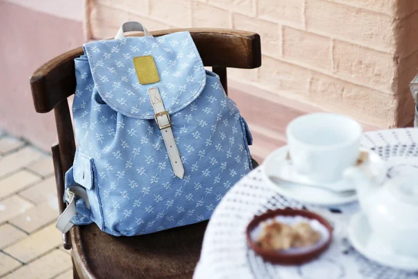 Backpack on the chair of cafe — Stock Photo, Image