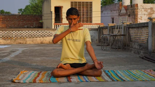 stock image young man doing yoga in the morning at roof.