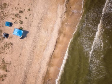 Aerial view of the sandy beach and stormy sea with amazing waves, scenic seascape, outdoor travel background, summer holidays concept, Azov sea, Ukraine
