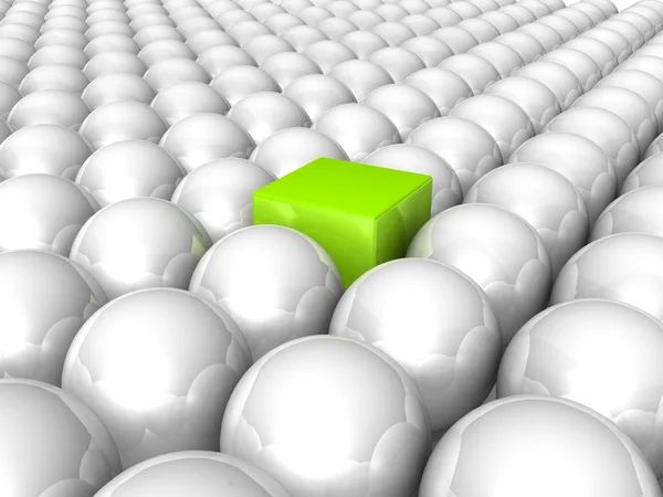 Green cube among white spheres — Stock Photo, Image