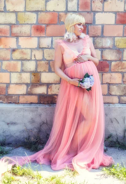Pregnancy woman in a pink dress