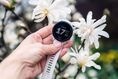 04.21.2021 Kyiv, Ukrayna. Beyaz bantlı Garmin Forerunner 745 spor saati.
