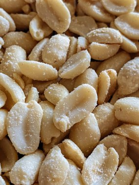 Roasted peanuts, salty snacks. Peeled peanuts for background, top view.