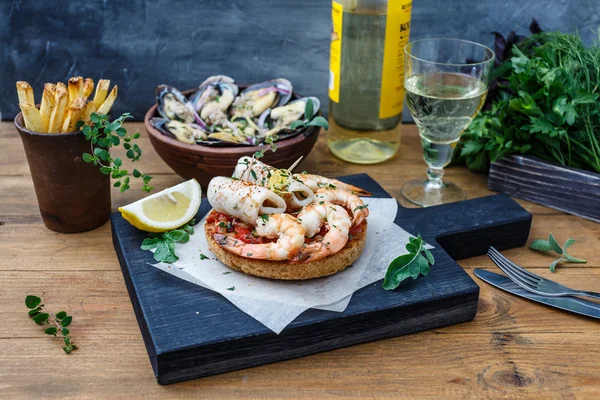 Bruschetta con gambas sobre tabla de cocina rústica —  Fotos de Stock