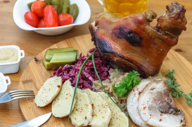 Haşlanmış lahana, salata ve birayla Eisbein.