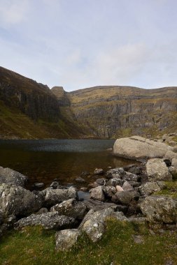 vertical image of a landscape of nature. Mountain with Irish glacial lake. Comeragh Mountains, Waterford, Ireland
