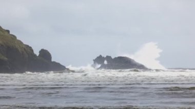 Ocean waves crashing on isolated rocks in the middle of the sea off the southern coast of Ireland. County Waterford. 