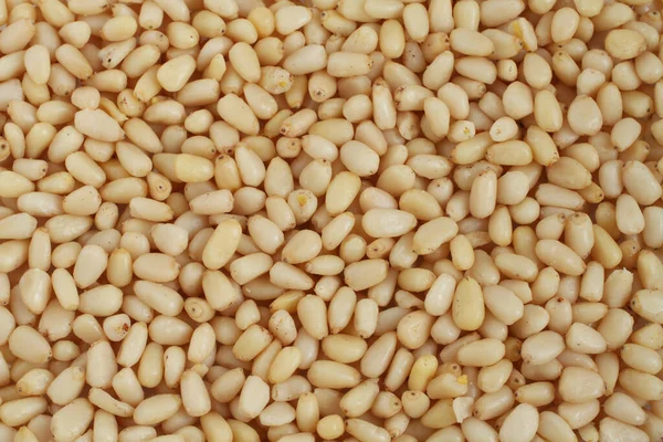 Livsmedelsbakgrund Skalade Cedernötter Som Ligger Godtyckligt — Stockfoto