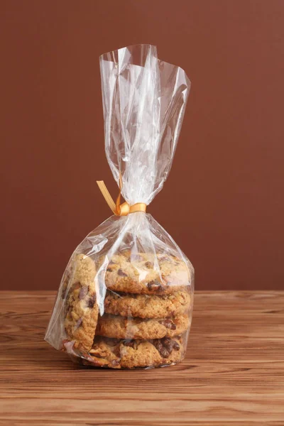 Oatmeal Cookies Walnuts Raisins Transparent Bag Wooden Table Closeup — Stock Photo, Image