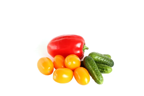 Red paprika, yellow plum tomatoes and cucumbers on white background — Stock Photo, Image