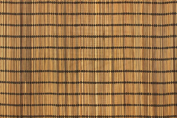 Brown toned bamboo sticks bound with black threads background — Stock Photo, Image