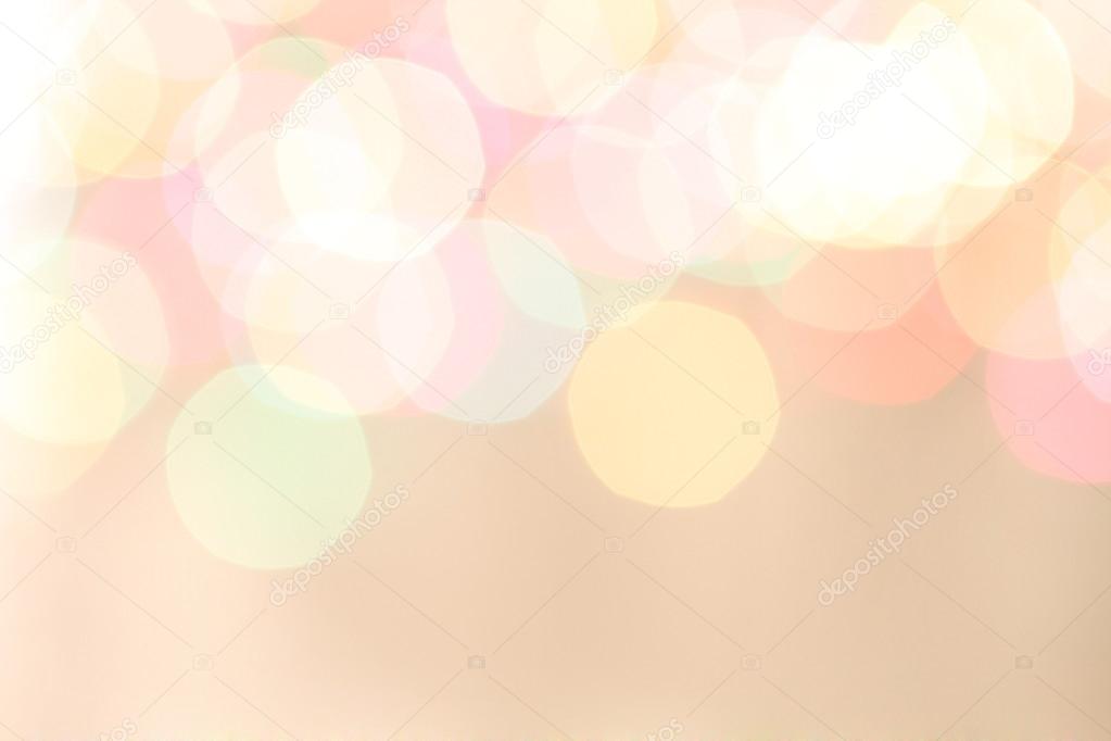 Blurred colored lights on beige background
