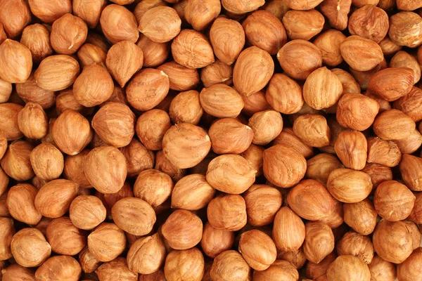 Hazelnut Background. Heap of peeled hazelnuts. — Stock Photo, Image