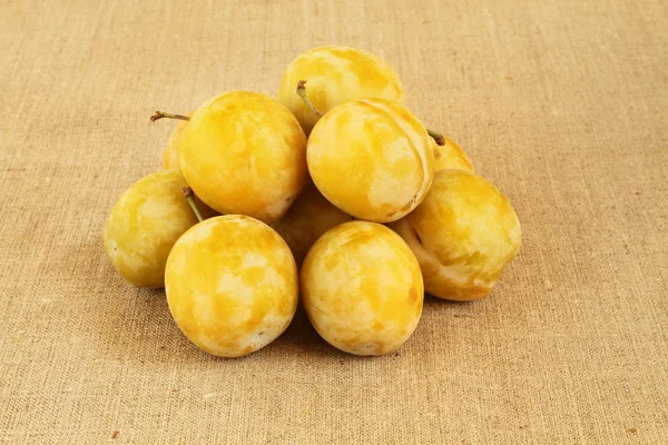 Ripe yellow plums (Yellow Greengage) on linen cloth. Closeup