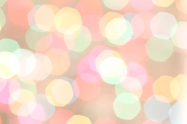 Pembe bir arka plan üzerinde renkli ışıklar bulanık