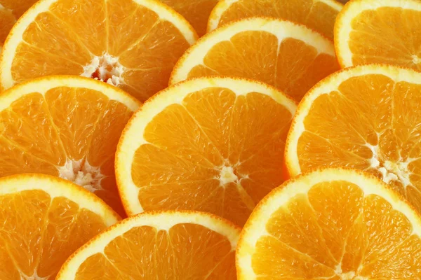 Voedsel achtergrond - segmenten van rijp oranje fruit — Stockfoto