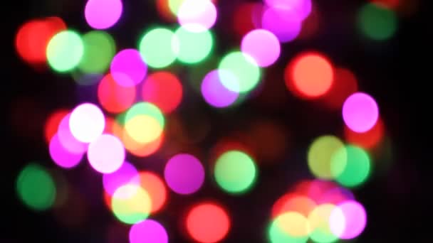 Defocused colorful lights flickering on black background — Stock Video