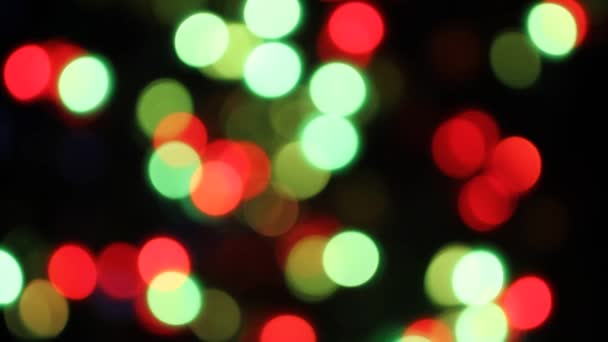 Lumières colorées déconcentrées scintillant sur fond noir 