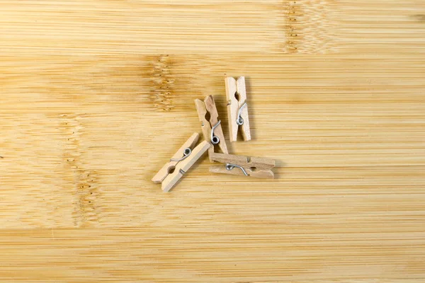 Wooden Clothespins Light Yellow Bamboo Background Top View — Stock Photo, Image
