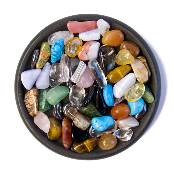 Colección de piedras preciosas semi-preciosas en frasco de vidrio pequeño sobre fondo de pizarra negro — Foto de Stock
