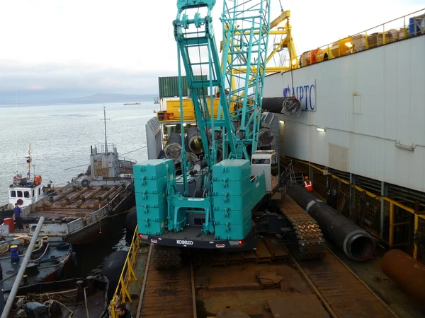 Deck pipe-laying vessel. pipes, valves and other equipment on the deck.