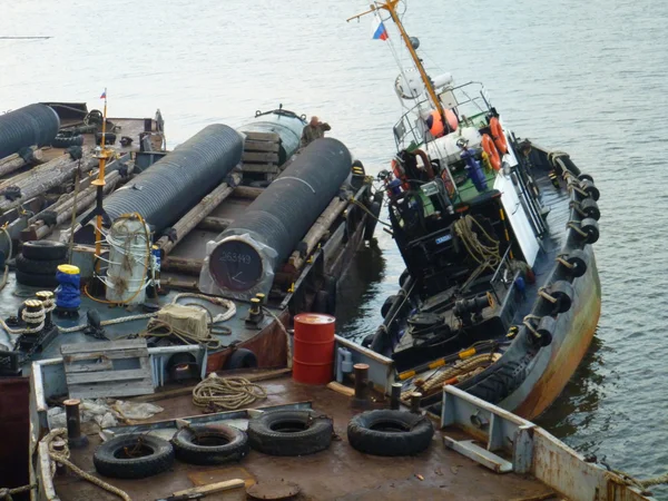 Deck pipe-laying vessel. pipes, valves and other equipment on the deck.