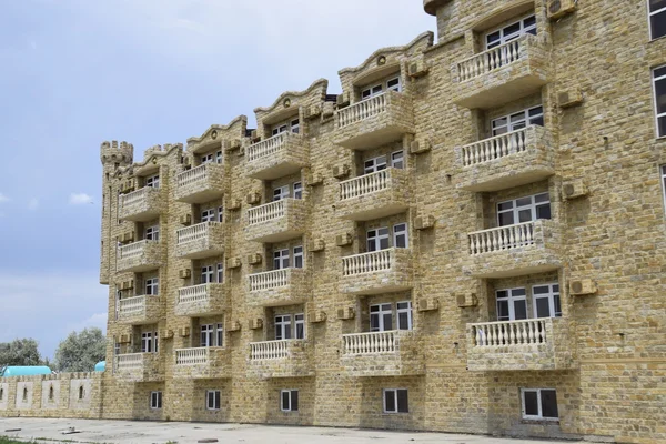 The hotel building, covered with decorative stone