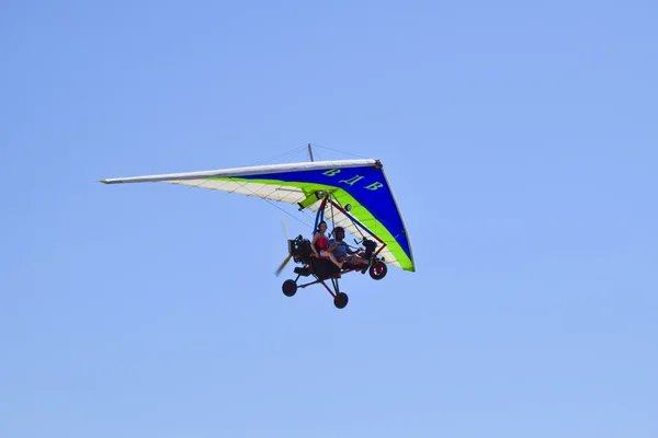 Dreirad fliegt mit zwei Personen in den Himmel — Stockfoto