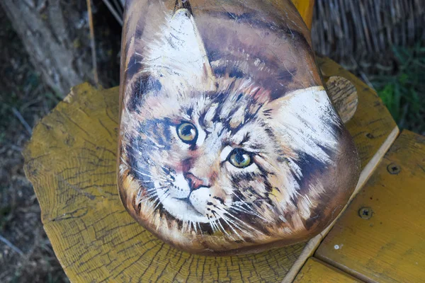 Cat, painted on a rock. Figure cat muzzle on a large stone.