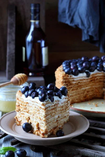 Piece of honey cake decorated with blueberry — Stock Photo, Image